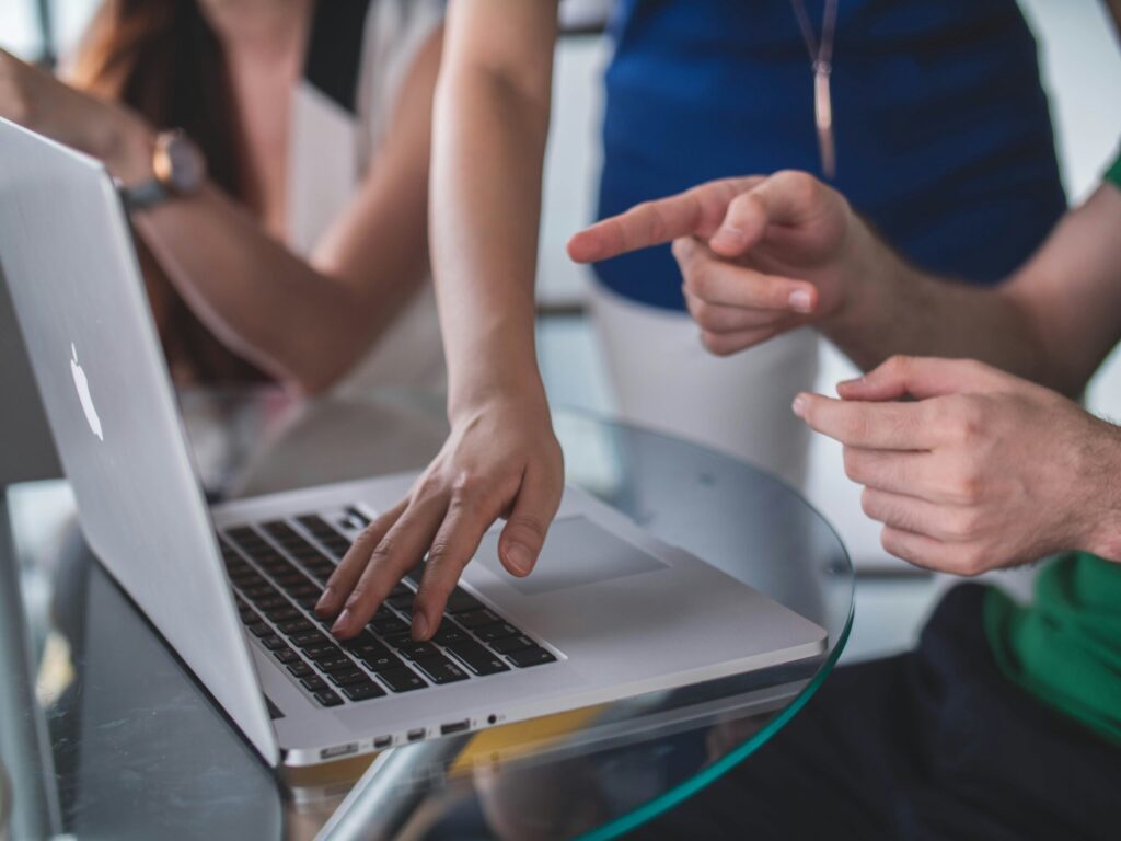 A computer user receiving guidance from a colleague